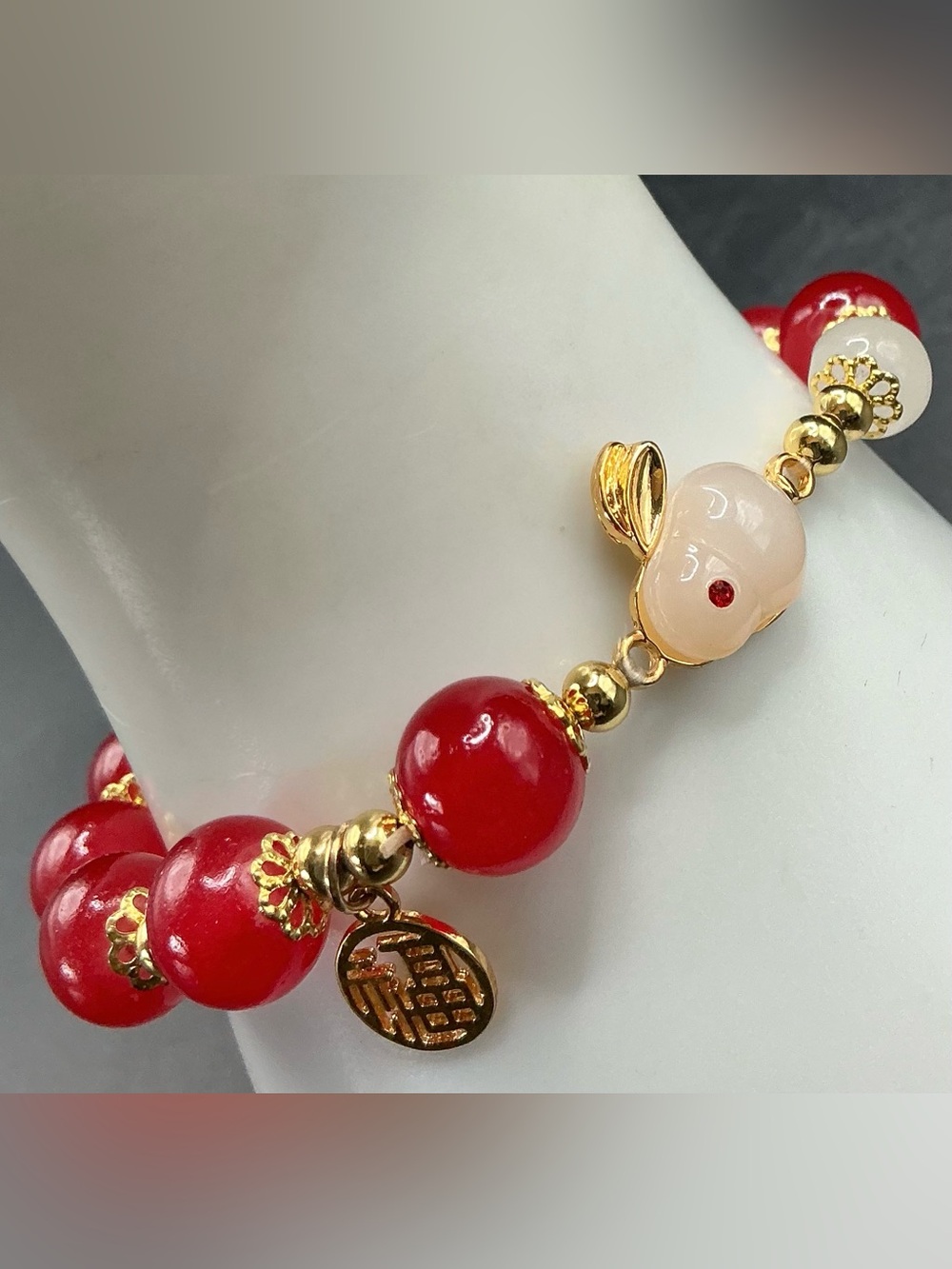 GOLD TONE AND RED BEADED BUNNY GOOD FORTUNE CHINESE SYMBOL STRETCH BRACELET